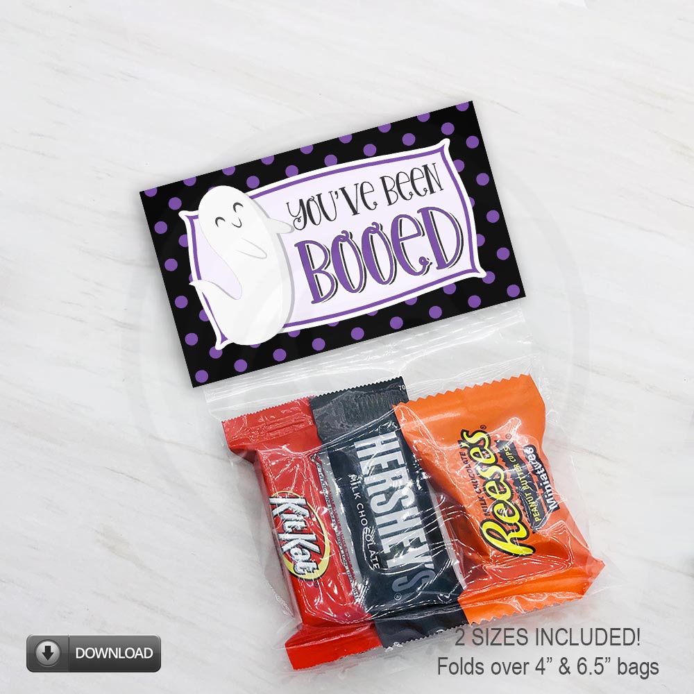 Printable Halloween bag topper with “You’ve Been Booed” wording, a smiling white ghost, and a black border covered in purple polka dots, available for 4" and 6.5" bags.