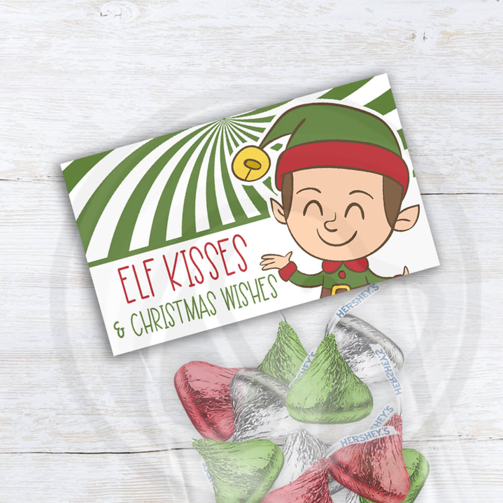 Elf Kisses and Christmas Wishes printable treat bag topper featuring cute elf illustration and green candy swirl design for Christmas candy gifts.