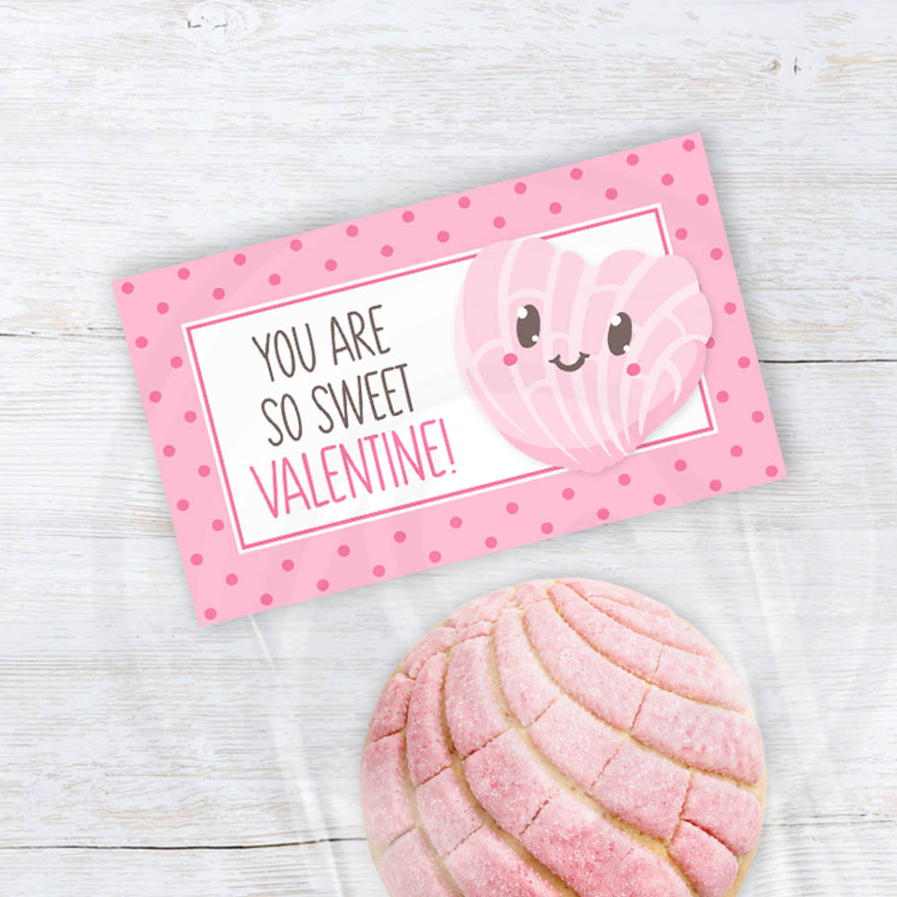 Printable Valentine treat bag topper with a smiling pink concha illustration and polka dot border.