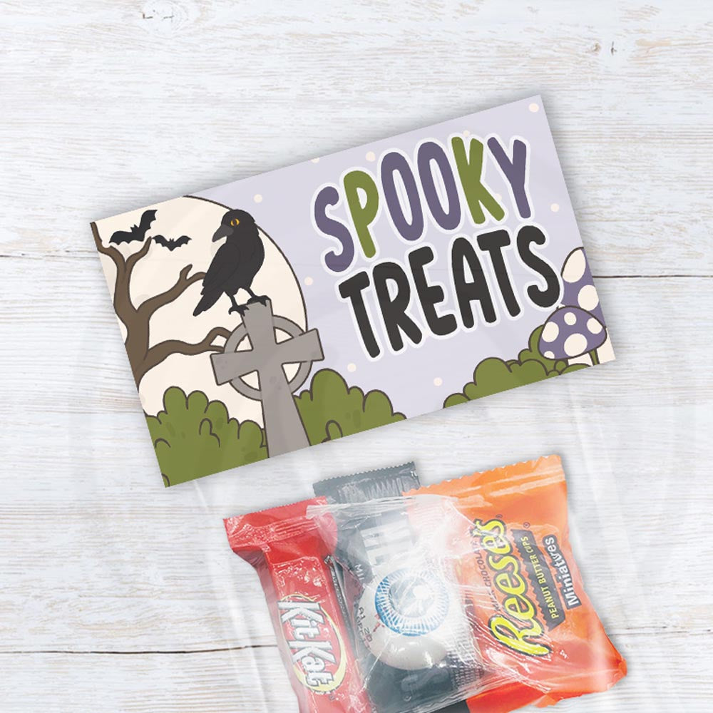 Spooky Treats printable Halloween bag topper with a raven, bats, moon, gravestone, mushrooms, and purple and green accents.