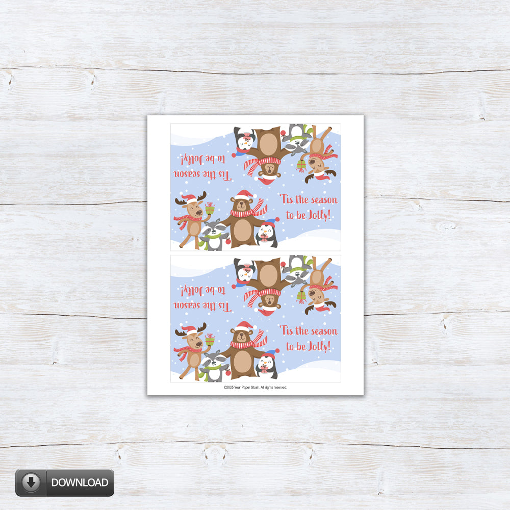 Printable “’Tis the Season to Be Jolly” holiday treat topper featuring reindeer, bear, penguin, and badger in scarves and Santa hats on a snowy blue background — perfect for folding over 4" and 6.5" holiday treat bags.