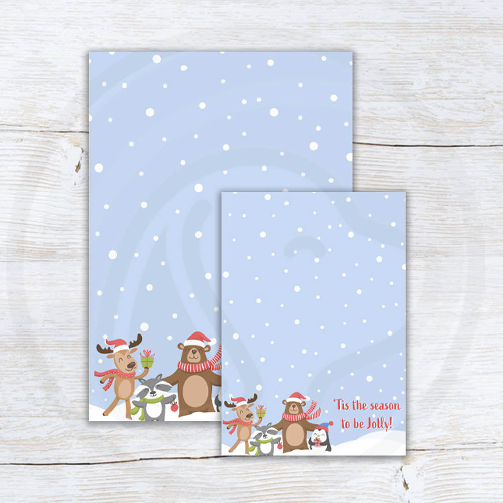 Printable “’Tis the Season to Be Jolly” cookie card featuring cute woodland animals — reindeer, bear, penguin, and raccoon — on a snowy blue background; two sizes included (3.5x5 and 5x7).