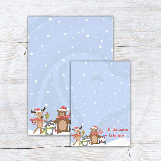 Printable “’Tis the Season to Be Jolly” cookie card featuring cute woodland animals — reindeer, bear, penguin, and raccoon — on a snowy blue background; two sizes included (3.5x5 and 5x7).