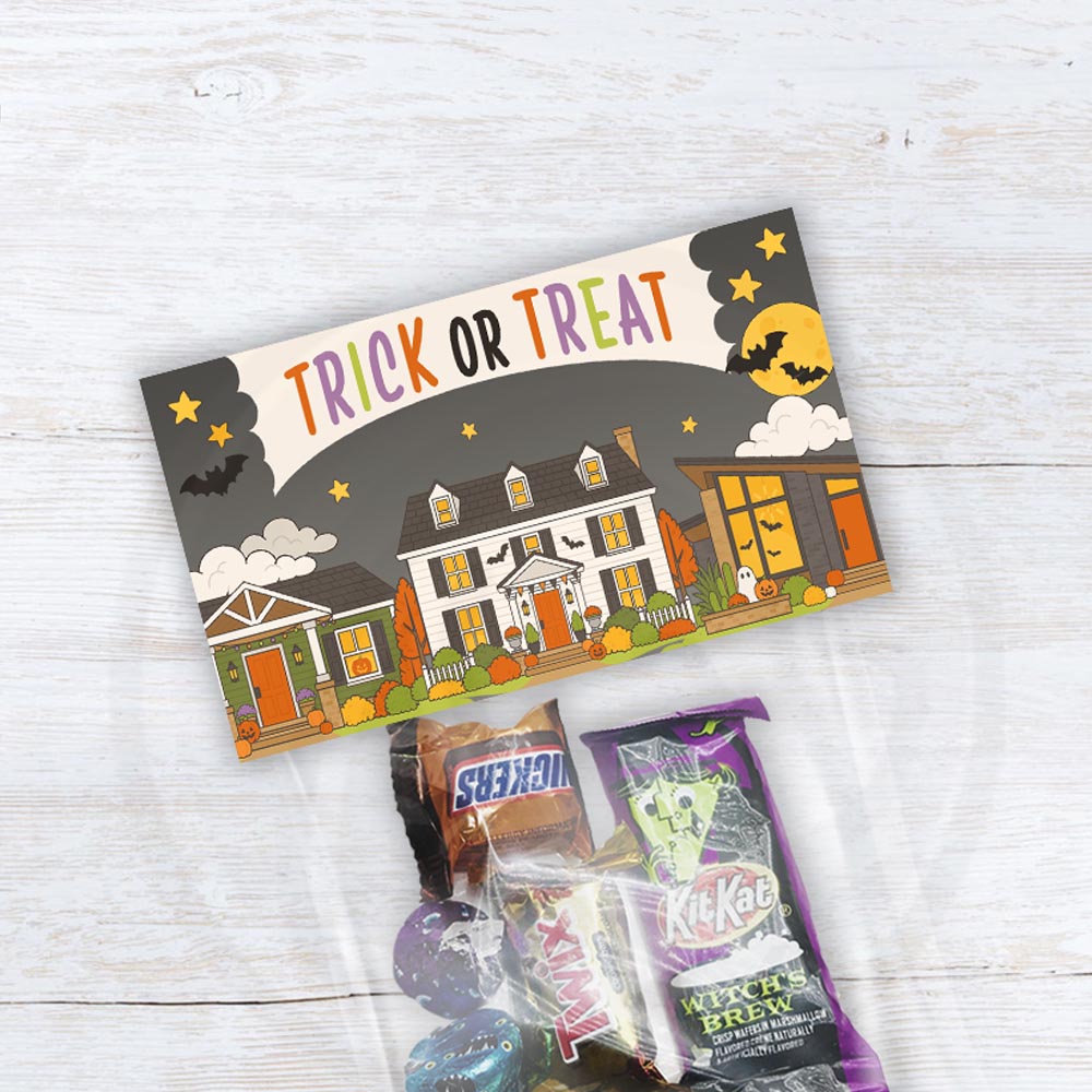 Printable Trick or Treat Halloween treat bag toppers featuring decorated neighborhood houses, bats, pumpkins and moons with an optional From area.