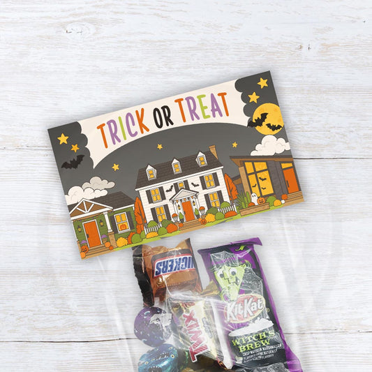 Printable Trick or Treat Halloween treat bag toppers featuring decorated neighborhood houses, bats, pumpkins and moons with an optional From area.