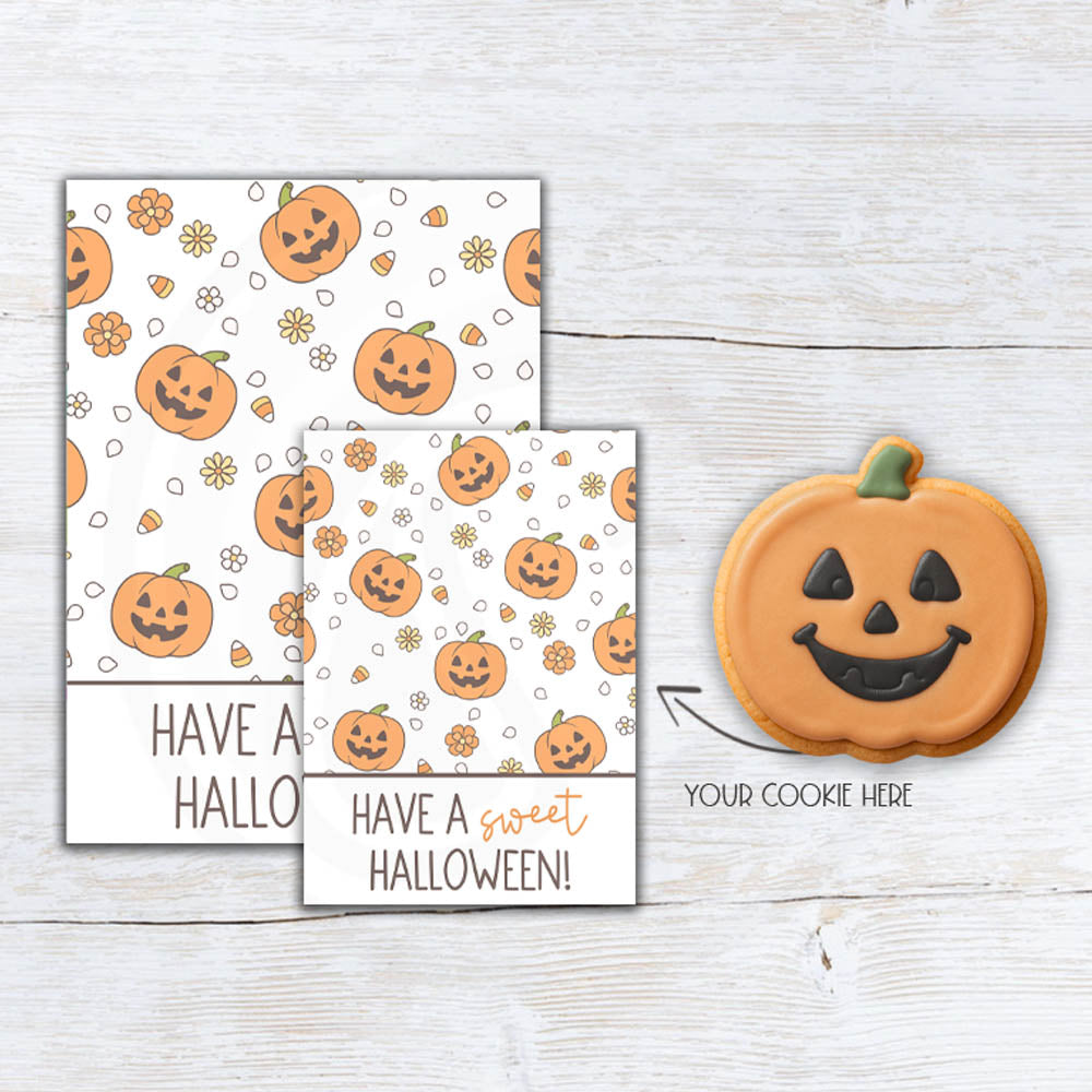 Sweet Halloween pumpkin cookie backer with smiling jack-o'-lanterns, candy corn, and daisies for cookies, treats, party favors, and boo baskets.